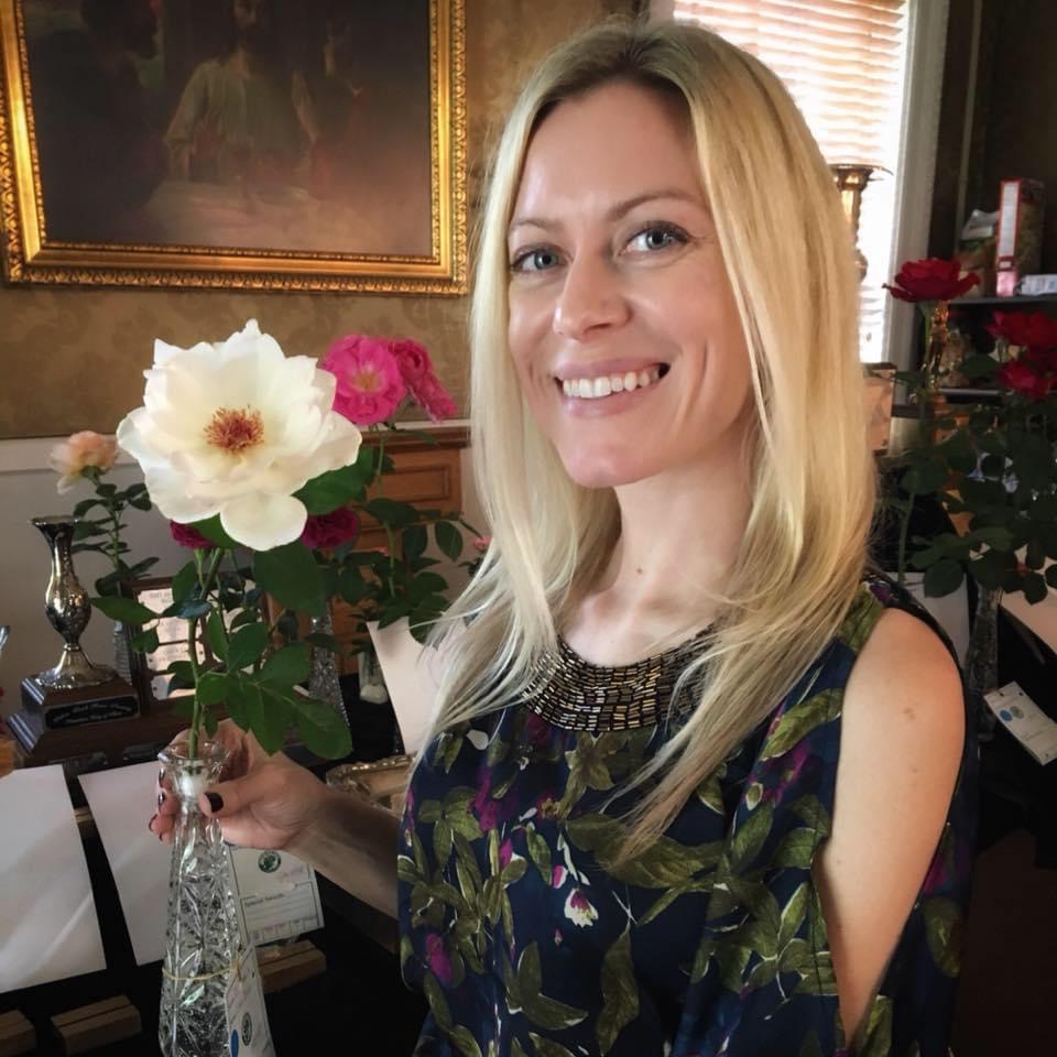 Sue Longhini holding a white rose