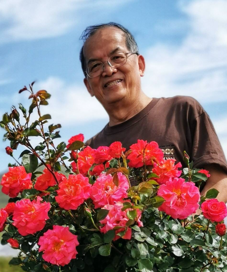 Ping Lim standing with roses